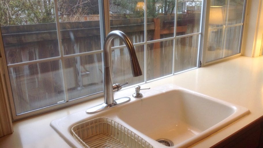 Kitchen sink with new faucet in front of window Kitchen sink with new faucet in front of window
